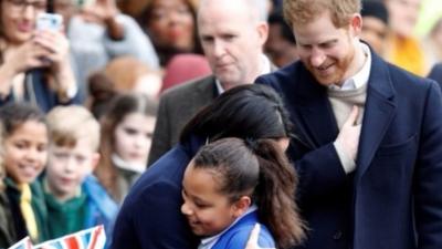 Meghan hugging schoolgirl