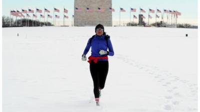 Jogger makes her way through the snow in Washington