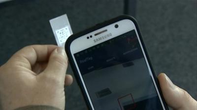 A smartphone reads the anti-counterfeit label