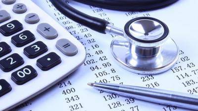 Calculator, stethoscope, pen and numbers