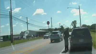 The officer pulling over a vehicle.