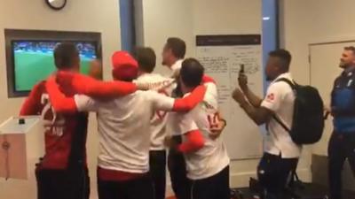 England's cricketers celebrate the success of the football team