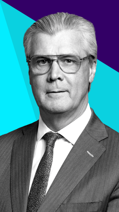 Reform UK Scotland leader Malcolm Offord smiles at the camera. He is wearing a suit and tie.