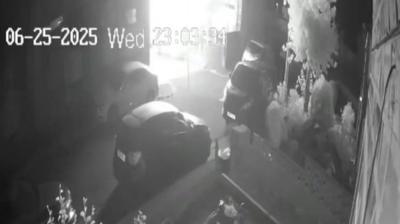 A black and white still from a security camera shows a terraced house engulfed in a ball of bright light moments before it exploded.