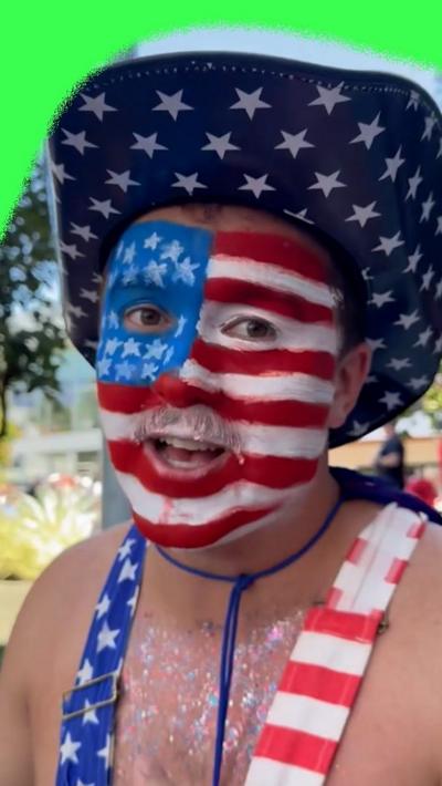 A USA soccer fan. He is wearing a USA cowboy hat and has the USA flag painted on his face.