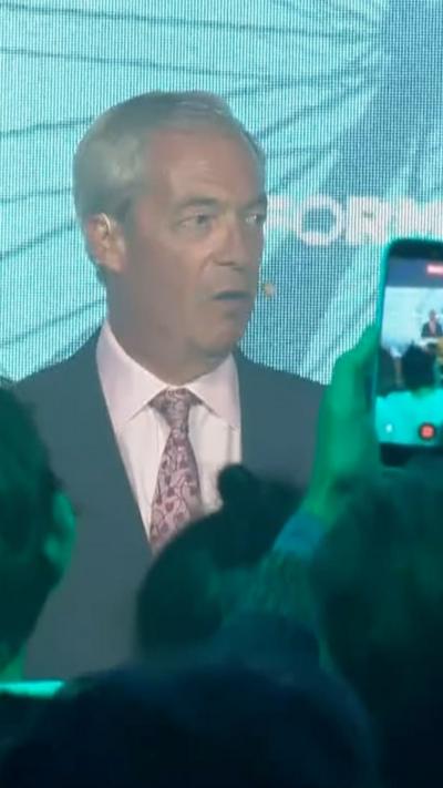 Farage speaking to a Reform UK crowd.
