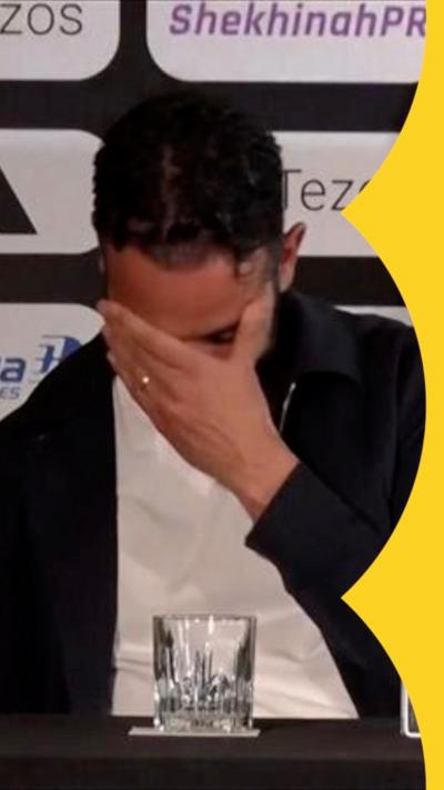 Ruben Amorim puts his hand over his face at a press conference