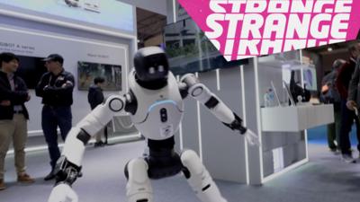 a dancing robot and the Strange logo