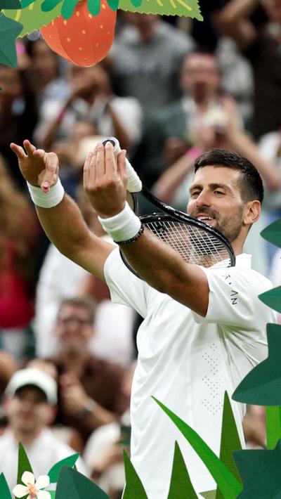 Novak Djokovic mimes playing the violin on his tennis racquet, a celebration chosen by his daughter Tara