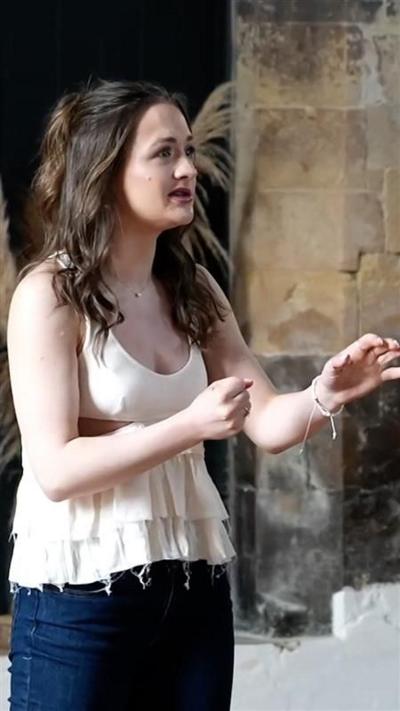 Actor with long, dark, hair in song as she auditions for the pantomime role of Belle