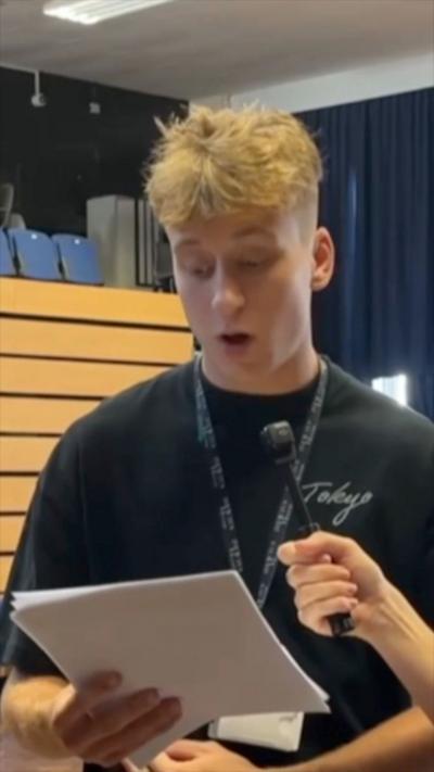 Blonde teenage boy talking about his exam results 