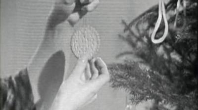 Valerie Singleton holds an edible Christmas tree decoration for birds