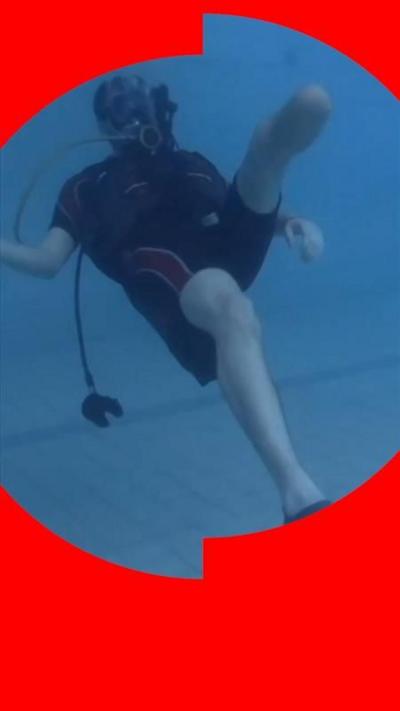 Man wearing scuba diving equipment in swimming pool
