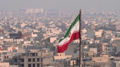 iran flag flying over city