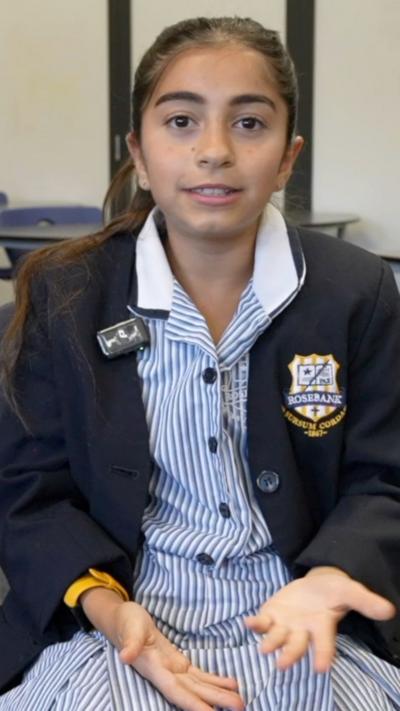 Girl sitting in her school uniform in a classroom