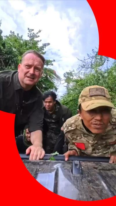 Quentin Sommerville and the young rebels on an open top vehicle driving through jungle