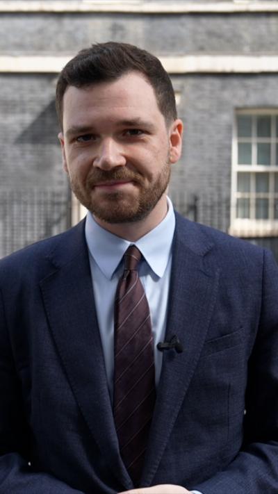 Henry Zeffman outside Downing Street wearing a suit 