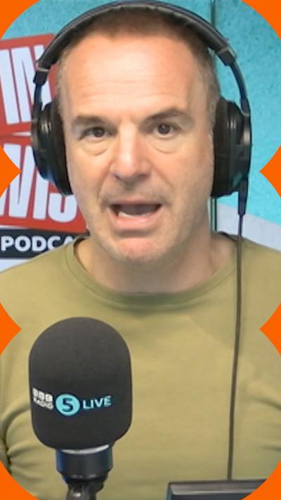 A man with short hair speaks into a microphone