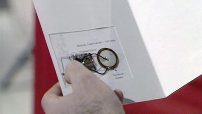 A musical tune player mechanism inside a musical christmas card