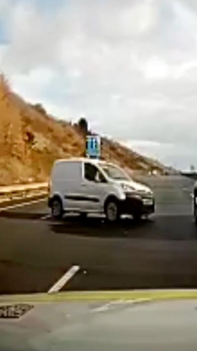 A white van blocks two lanes of the motorway.