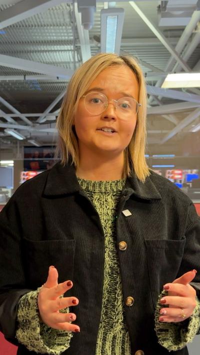 Catherine Moore has blonde hair and glasses.