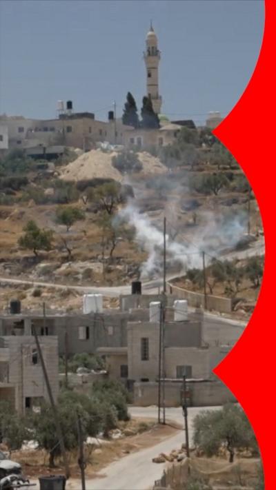 Smoke rises from a building made of white stone.