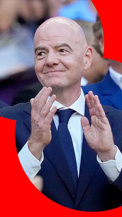 Fifa president Gianni Infantino wearing a suit and clapping