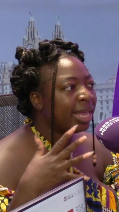 women in colourful African dress talking in studio 