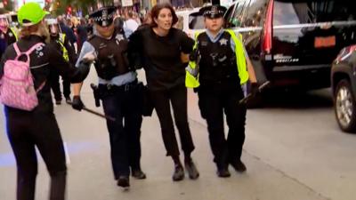 Woman being taken away by police