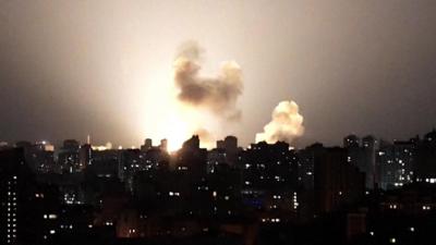 Ukraine skyline at night lit up by a missile