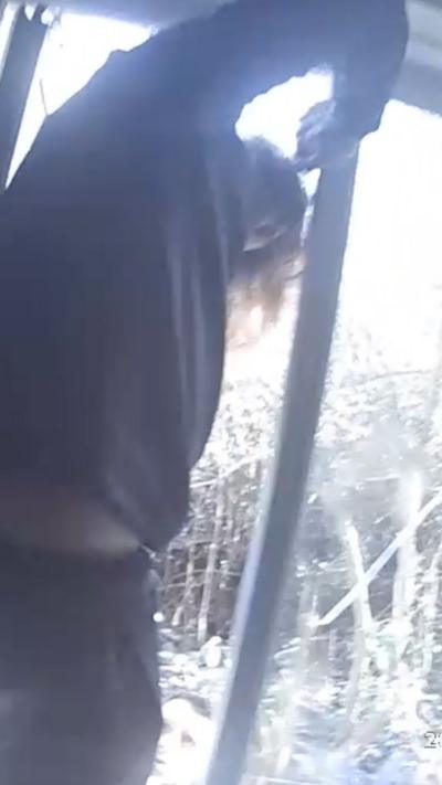 An image of a man trying to get out of a window