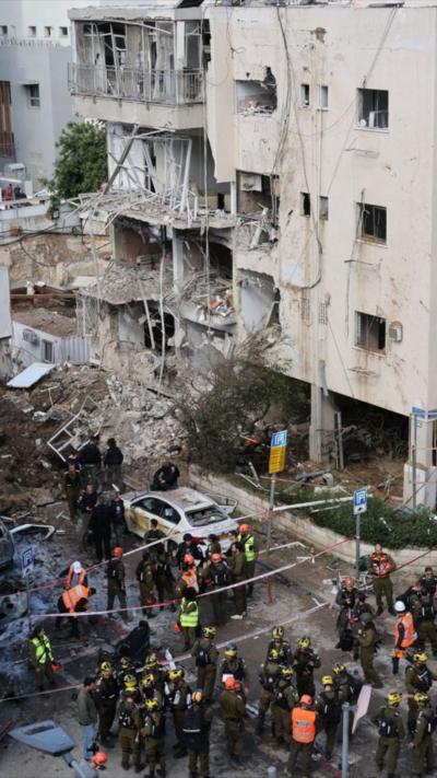 Damaged building and emergency workers