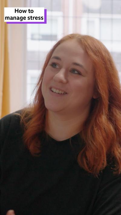 Rebecca, a red-haired woman, smiles. In the top corner there is a white box, containing the words: "How to manage stress"