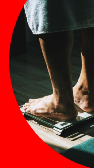 A person standing barefoot on a set a scales