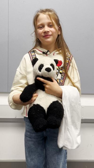 A child holding a teddy
