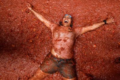 Woman bathing in tomato during La Tomatina Festival