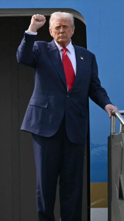 Trump raises his fist on Air Force One as he leaves South Korea