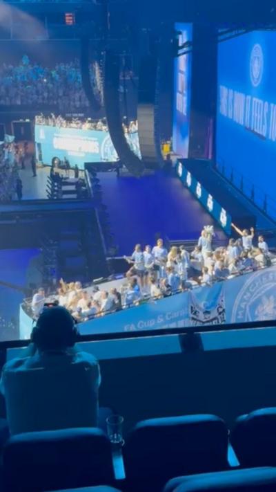 The city open-top bus is in the Co-op Live arena , it is in the blue and white City branding and has players stood on top waving to the crowd