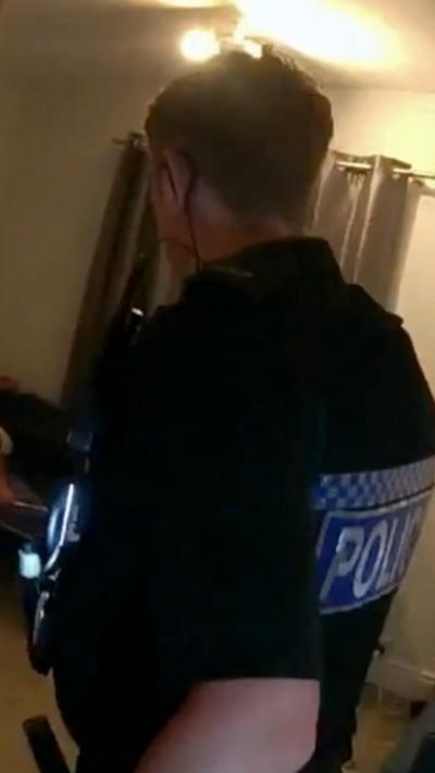 Police enter a bedroom to arrest a man