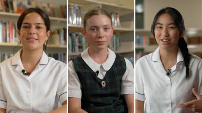 Split screen of three teenage girls. They are all wearing school uniforms and are sitting in front of a bookshelf