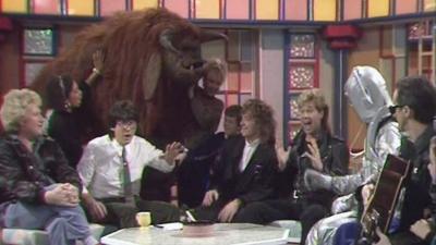 Ludo, Colin Baker, a Cyberman, Glass Tiger in the Saturday Superstore studio.