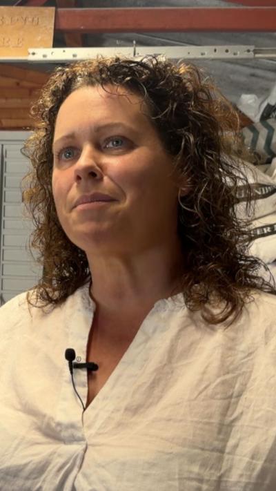 woman with curly hair and white shirt