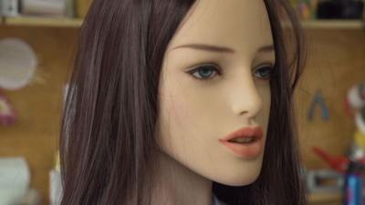 Close-up on the face of a robot made to resemble a female human