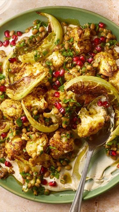 plate of roasted cauliflower ontop of tahini yog 