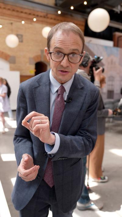 Chris Mason wears a blue suit 