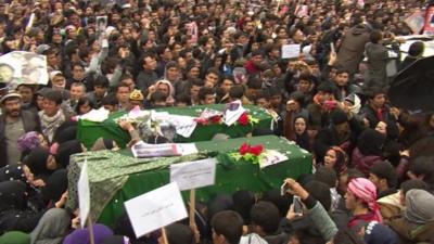 Protesters carry the coffins of the Hazara citizens killed