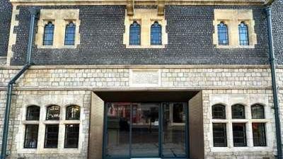 The exterior of the Maison Dieu Hall in Dover, with white stone windows and flint walls.