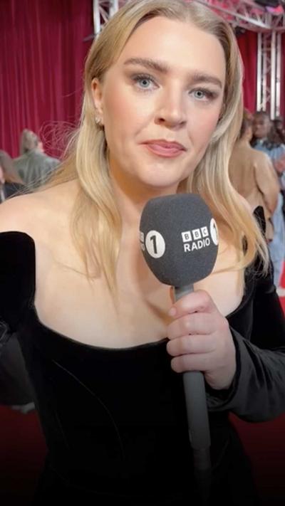 Self Esteem holding a Radio 1 microphone.