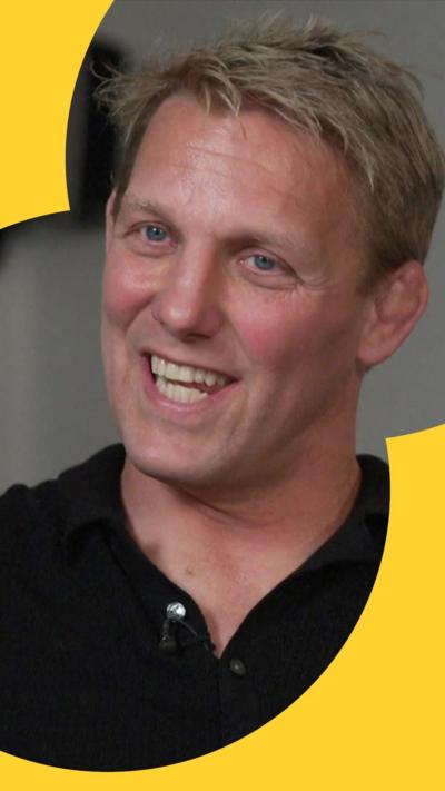 A man with blonde hair and blue eyes