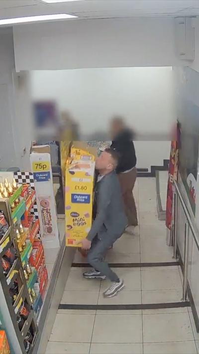 A man lifting a mini eggs display 